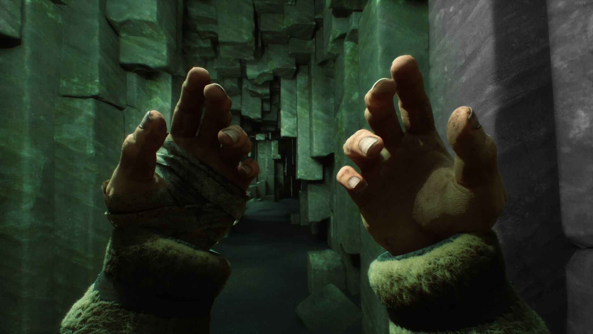 Stygian: Outer Gods first-person screenshot: two bandaged hands raised in a green-lit corridor.